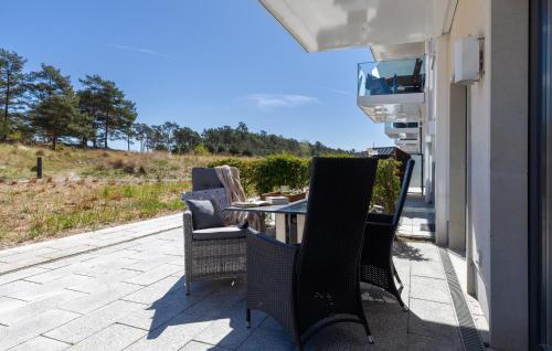 a table and chairs on a patio with a view at Moon in Binz