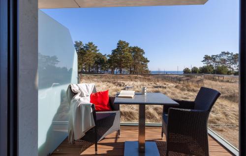 a table and chairs on a balcony with a view of the ocean at Amber in Binz