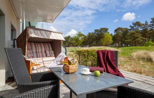 a table and chairs on a patio with a view of a field at Amber in Binz