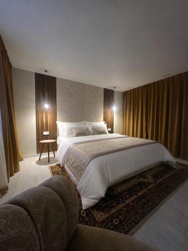 a bedroom with a large bed and a couch at Баракат in Chon-Sary-Oy