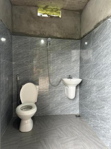 a bathroom with a toilet and a sink at Sapa Local Guide Homestay Trek 2 Days 1 Night or Multi-Day Trekking in Lao Cai