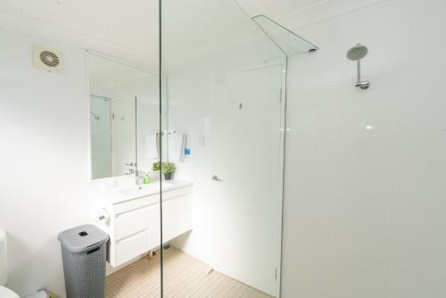 a bathroom with a sink and a glass shower at Amity Escape - Sleeps 14 in Amity Point
