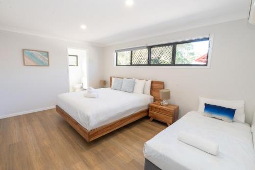 a bedroom with two beds and a window at Amity Escape - Sleeps 14 in Amity Point