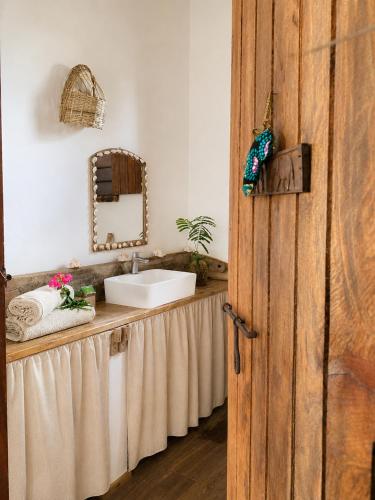 a bathroom with a sink and a mirror at Kita Ocean House in Kiwengwa