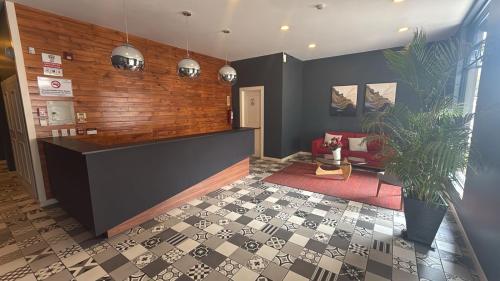 a lobby with a reception desk and a potted plant at Mumbai SkyLine Luxury Suite in Quito