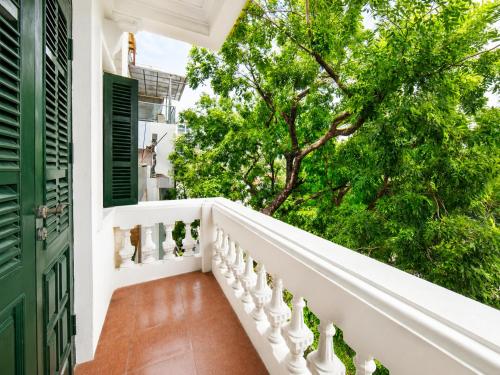 a balcony with white railings and trees at Pavilion Essence Hanoi Hotel in Hanoi