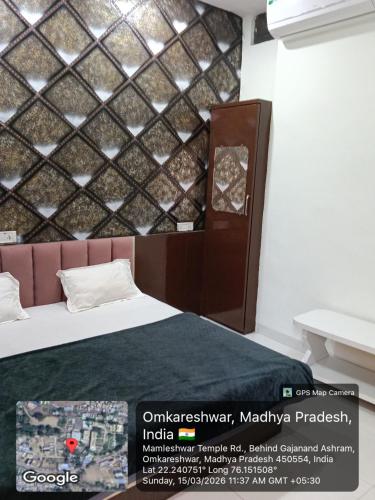 a room with a bed and a wall at Hotel Sadashiv in Godarpura