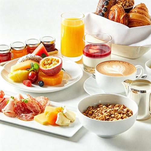 a table with plates of breakfast foods and drinks at InterContinental Fuzhou by IHG in Fuzhou