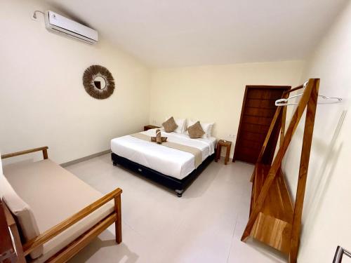 a bedroom with a bed and two beds in it at Kapal Dream Homestay in Selong Belanak