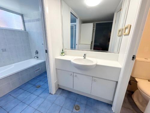 a bathroom with a sink and a tub and a toilet at Ocean Shores Apartment 14 - Bring your own linen. in South West Rocks