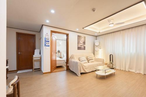 a bedroom with a bed and a table in a room at Stay GAON in Seoul