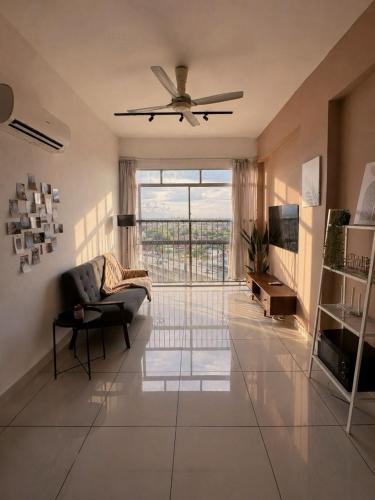 a living room with a couch and a ceiling fan at Taiping Centre Point Suite 7 by BWC in Taiping