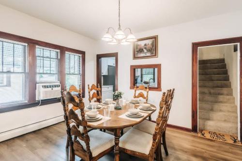 a dining room with a wooden table and chairs at Minnehaha Falls Hideaway in Minneapolis