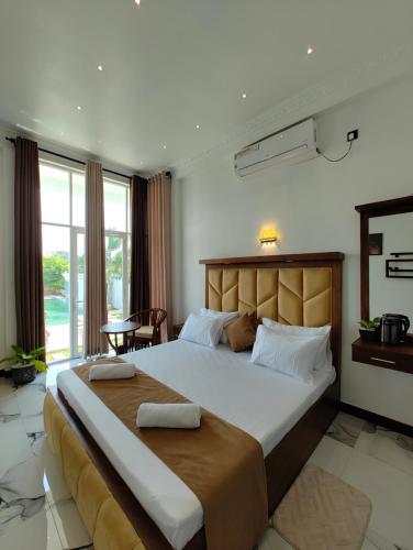 a bedroom with a large bed in a room at Panorama Safari Villa in Trincomalee