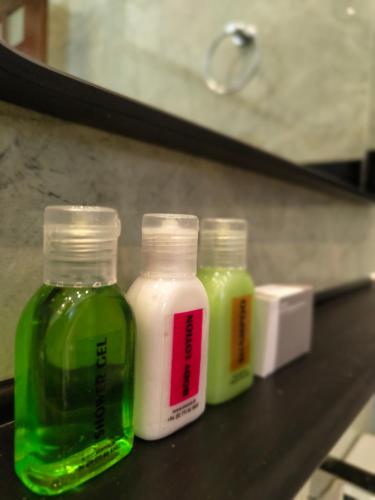 four bottles of different colored liquids sitting on a shelf at Panorama Safari Villa in Trincomalee