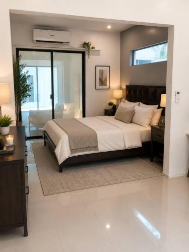 a bedroom with a large bed and a couch at Rosa Executive Residence in heart of Ormoc City in Ormoc