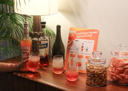 a table with two glasses and bottles of alcohol at Tokyu Stay Yotsuya - Shinjuku Area in Tokyo