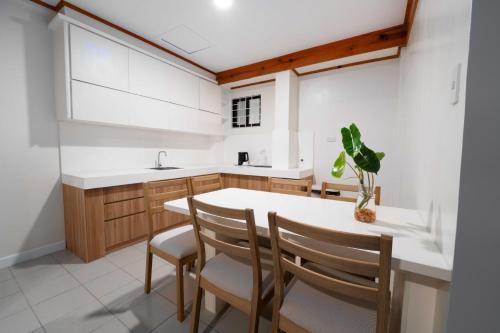 a kitchen with a white counter and wooden cabinets at Highland Nest in Baguio