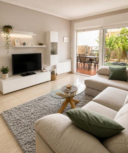 a living room with a couch and a tv at Bungalow with Pool & BBQ - Carabassi Beach 10' in Gran Alacant