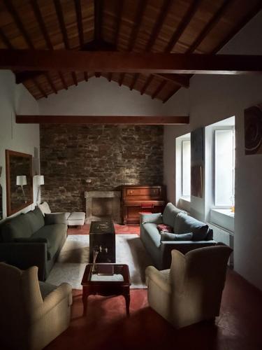 a living room with couches and a fireplace at Casa Malde in Cedeira