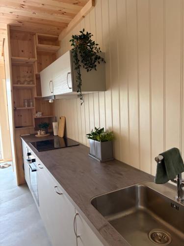 a kitchen with a sink and a counter top at Bird Nest in Bømlo