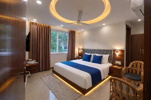 a hotel room with a bed and a large window at Sitara Premium Gangotri Palace, Tapovan in Rishīkesh