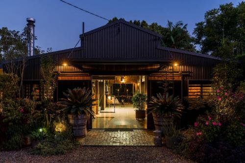a building with plants in front of it at night at The Bangalow Barn in Bangalow