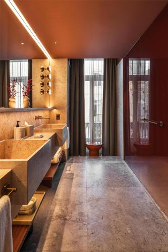 a bathroom with a large sink and a large mirror at Andaz Lisbon, By Hyatt in Lisbon