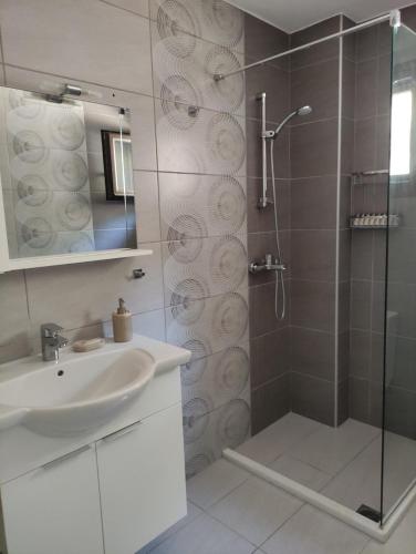 a bathroom with a shower and a sink at Celeste Syvota in Syvota