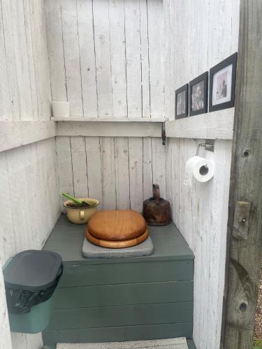 a toilet sitting on a shelf in a outhouse at Glamping - a living room overlooking the ocean in Hammarland