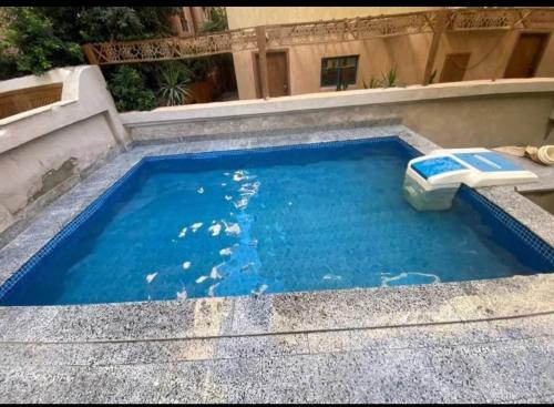 a swimming pool with a toilet in the water at CoCo Nest Cozy Modern Studio Near Mamsha Beach & Airport in Hurghada