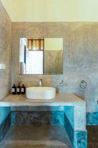 a bathroom with a sink and a mirror at Nova By Horizon Collection in Unawatuna