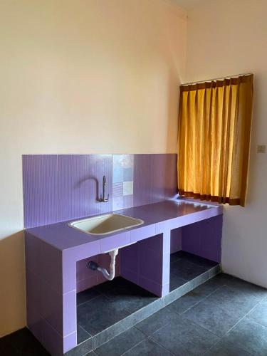 a bathroom with a sink and a purple counter at Kubu Jimbaran in Jimbaran