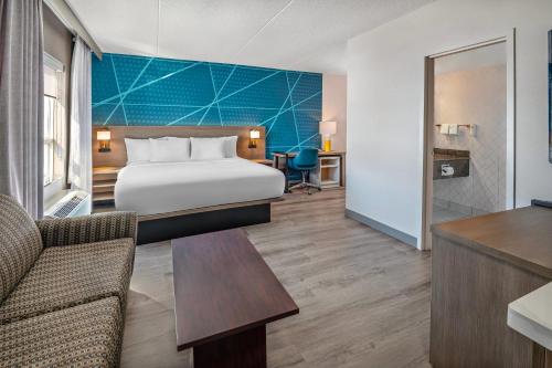 a hotel room with a bed and a desk at Comfort Inn in Mississauga