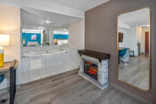 a living room with a fireplace and a tub at Comfort Inn in Mississauga