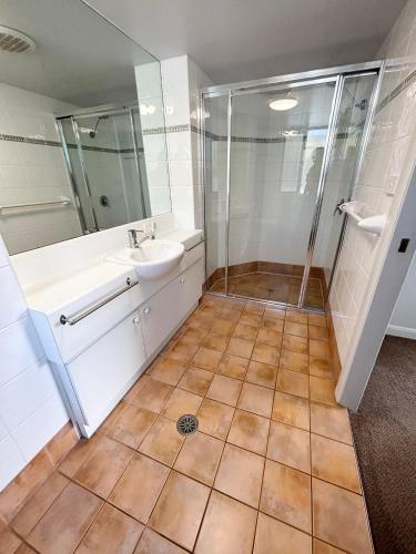 a bathroom with a sink and a shower at Ocean Shores Apartment 15 - Bring your own linen. in South West Rocks
