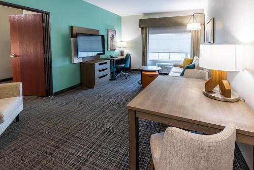 a living room with a couch and a table in a hotel room at Comfort Inn & Suites New Iberia - Avery Island in New Iberia