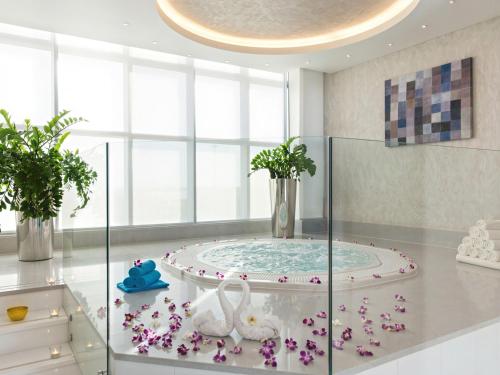 a bathroom with a tub with two swans on it at Novotel Abu Dhabi Gate in Abu Dhabi
