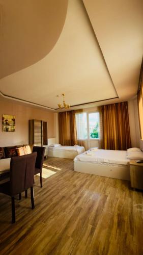 a large room with two beds and a couch at Golden Horizon House in Kobuleti