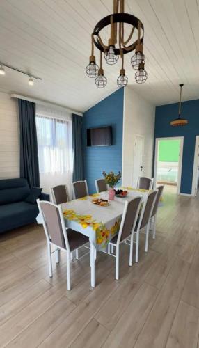a dining room with a white table and chairs at Kashka-Suu house in Verkhnyaya Alaarcha
