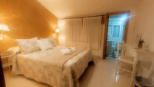 a bedroom with a large bed in a room at Casa BRAIS in Barreiros