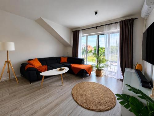 a living room with a couch and a table at Modern 2023 apartment in Kutno