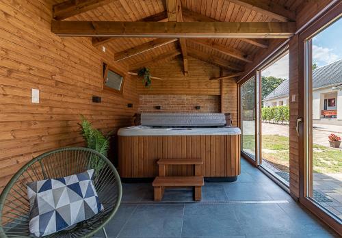 an outdoor kitchen with a grill on a patio at Adamkó Borkert Ház in Villány