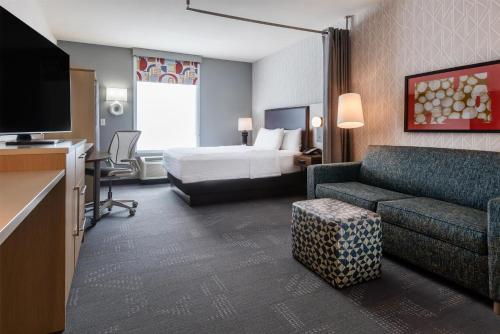 a hotel room with a bed and a couch at Home2 Suites by Hilton Gillette in Gillette