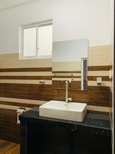 a bathroom with a sink and a mirror at Rawana Mountain View Homestay in Ella