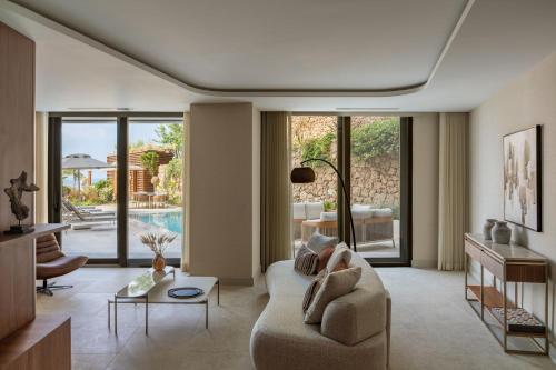 a living room with a couch and a table at Keyla Hotel & Beach - Adult Only in Antalya