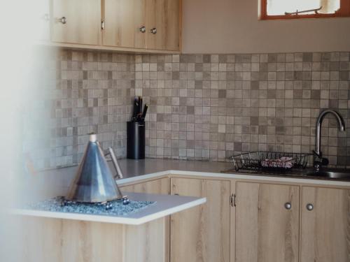 a kitchen with a counter with a funnel on it at Kameeldoring Camping & Tented Chalets in Kakamas