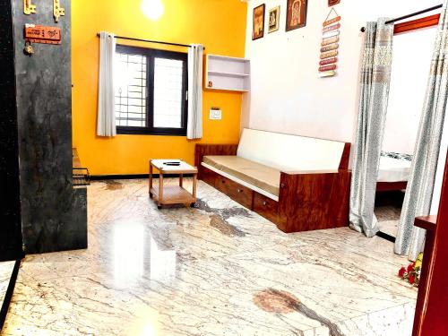 a room with a bed and a table in it at Keshu Home Stay Hampi in Hospet
