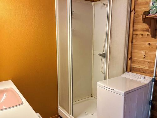 a bathroom with a shower and a white refrigerator at 8 person holiday home in Jelsa-By Traum in Jelsa