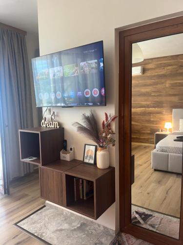 a living room with a flat screen tv on a wall at Sunset Yavorov Pomorie in Pomorie